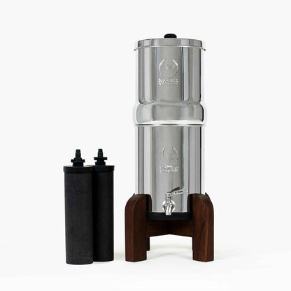 Phoenix Gravity  Stainless steel water filter with wooden base on a white background